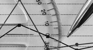 The image is zoomed in on a protractor and a pen.