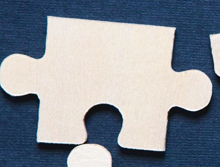 beige puzzle piece on a navy blue background