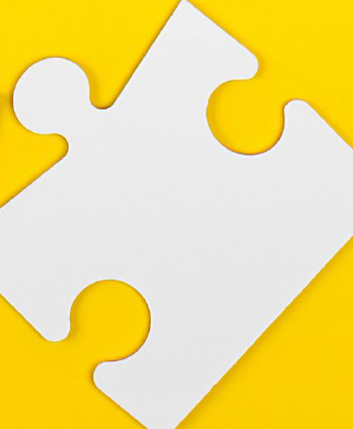 white puzzle piece on a yellow background
