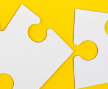 portions of white puzzle pieces on a yellow background